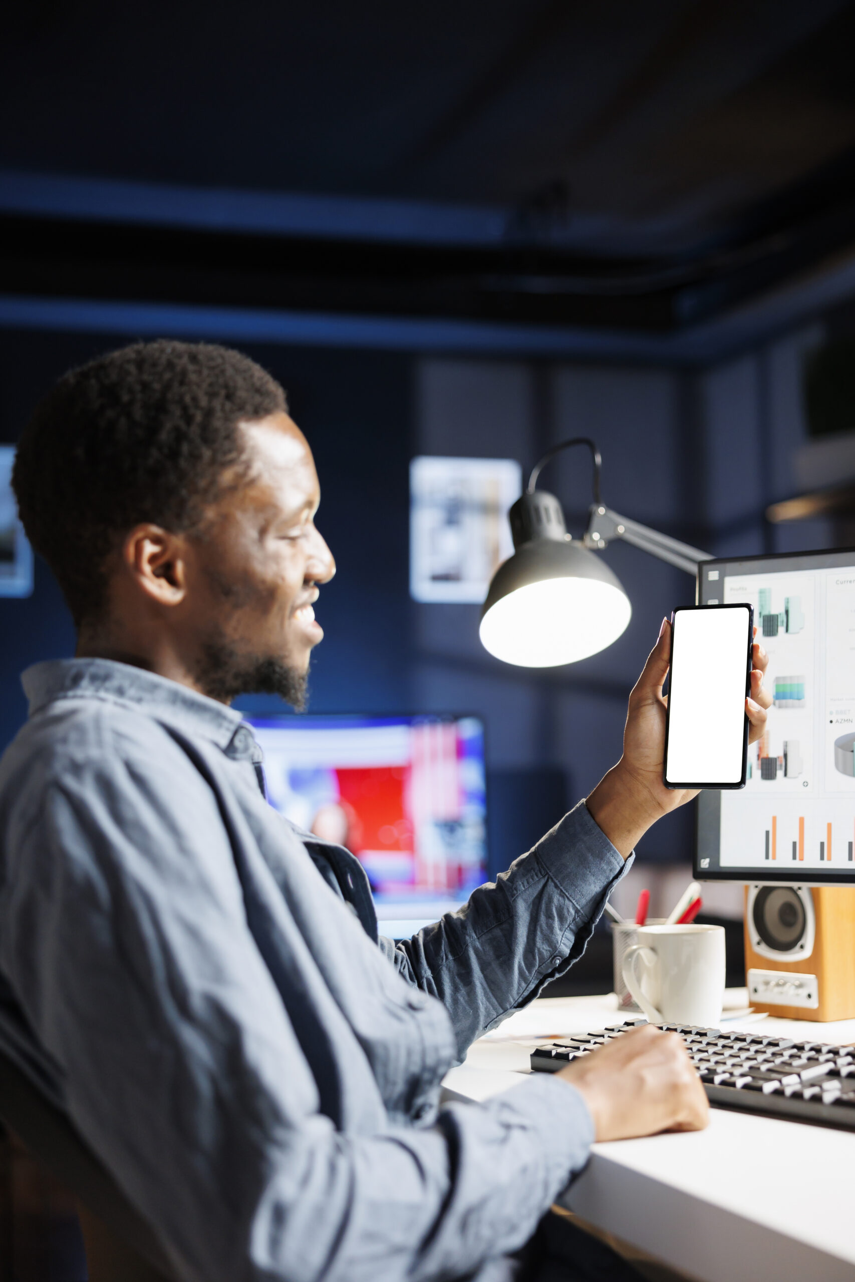 Young freelancer examines white screen on smartphone